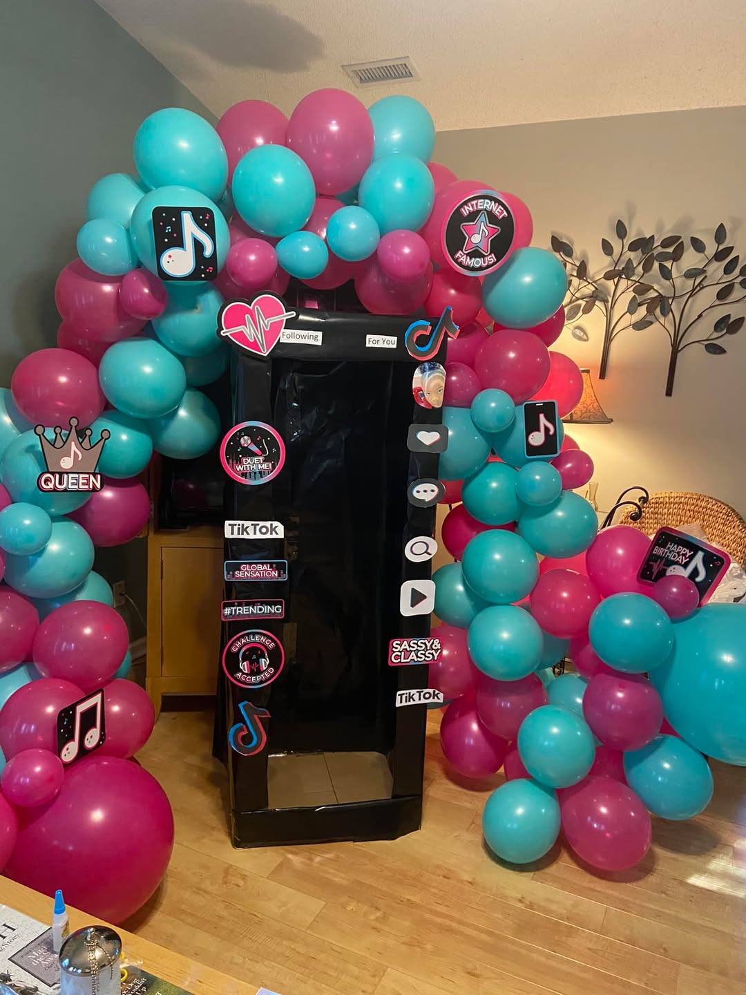 TikTok Themed Party - Teal and pink balloon arch with social media decorations by Buchannon Events
